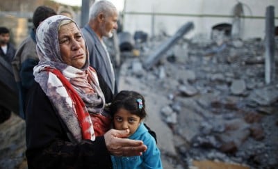 A Palestinian woman cries next to a relative's house after it was destroyed in what witnesses said was an Israeli air strike in Beit Lahiya in the northern Gaza Strip