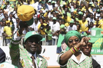 Zimbabwe President Robert Mugabe and his wife Grace arrive to address the final campaign rally of his ZANU-PF party in Harare