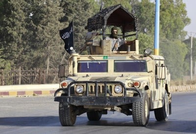 Militant Islamist fighters take part in a military parade along the streets of Raqqa