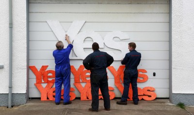 Employees of Gordon diesel services prepare to erect Yes campaign placards on their workshop in Stornoway on the Isle of Lewis in the Outer Hebrides