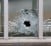A bullet's impact is seen on a window at the scene after a shooting at the Paris offices of Charlie Hebdo, a satirical newspaper,