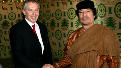 ARCHIVE PHOTO: Britain's Prime Minister Tony Blair (L) shakes hands with Libyan leader Muammar Gaddafi near Gaddafi's home town of Sirte May 29, 2007 (Reuters / Leon Neal)