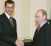 Russia's President Putin and Syrian President Bashar al-Assad  shake hands as they meet in Moscow