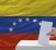 man voting on elections in venezuela in front of flag