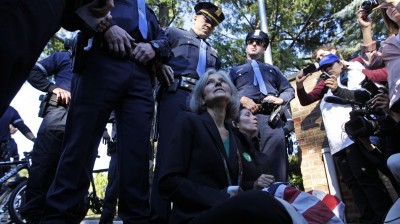 Green Party presidential candidate Jill Stein, left, and vice presidential candidate Cheri Honkala sit at the entrance to Hofstra University, Hempstead, N.Y., Tuesday, Oct. 16, 2012, after being informed that they wouldn’t be able to enter and participate in the second presidential debate. (AP Photo/Mary Altaffer)