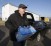 John Whitaker, executive director of Midwest Food Bank, carries a case of water that was donated to Flint residents on January 27. CREDIT: AP Photo/Darron Cummings